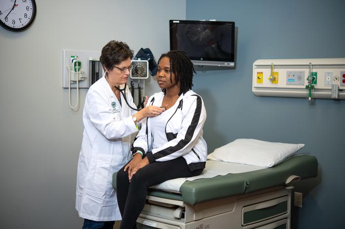 Nursing students taking care of a patient.